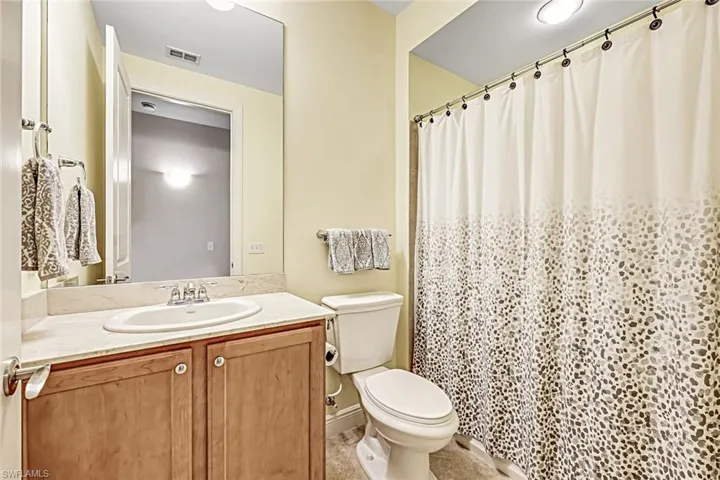 Full bathroom featuring vanity and a shower with curtain