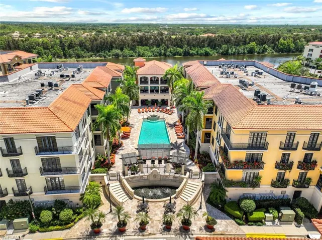 Aerial view of a pool and a large body of water