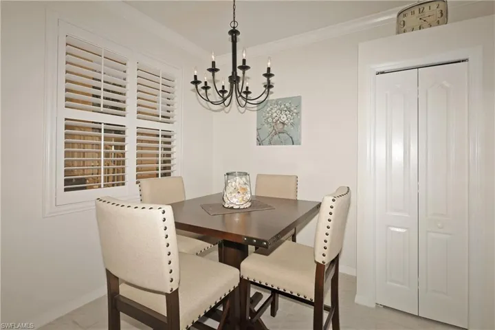 Breakfast nook with  chandelier and crown molding