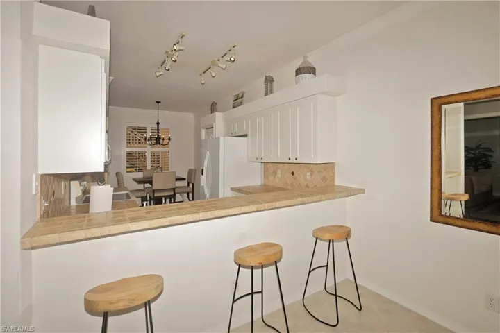 Kitchen featuring track lighting and breakfast bar
