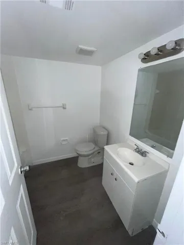 Bathroom with vanity and dark wood-type flooring