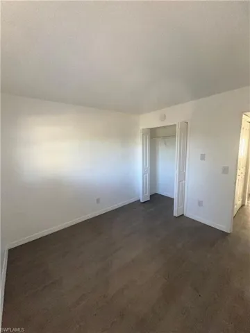 Unfurnished bedroom featuring baseboards and a closet
