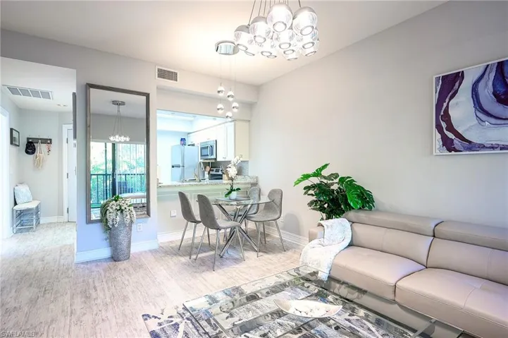 Living area with a chandelier and light wood-style floors
