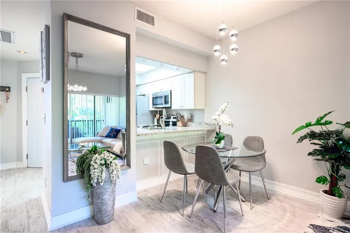 Dining room featuring light wood finished floors and a chandelier