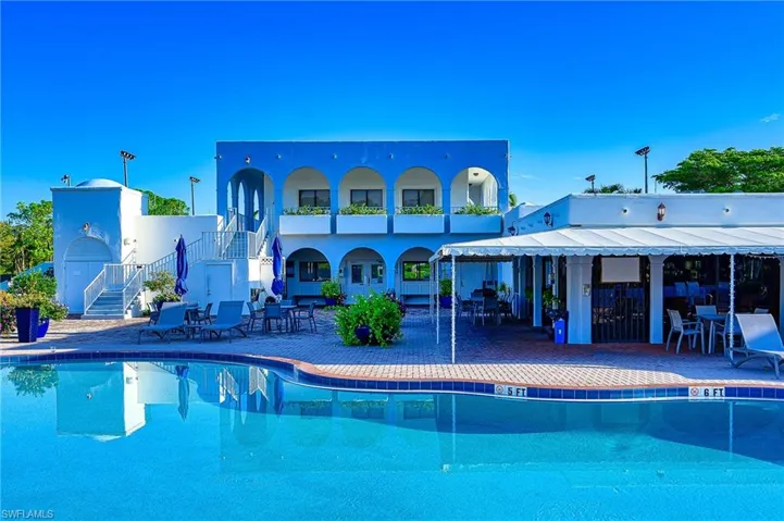 Community pool featuring stairway and a patio