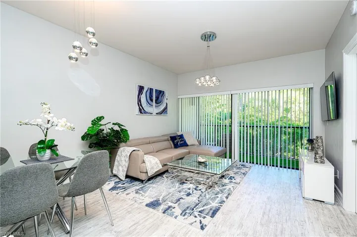 Living room featuring wood finished floors and a chandelier