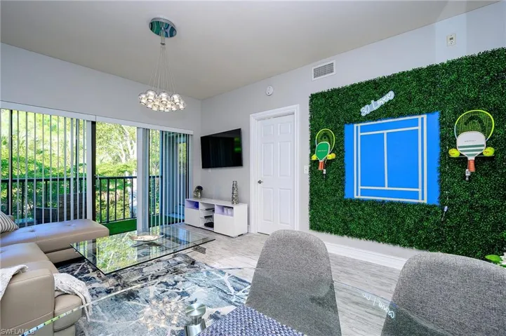 Living area with a chandelier and wood finished floors
