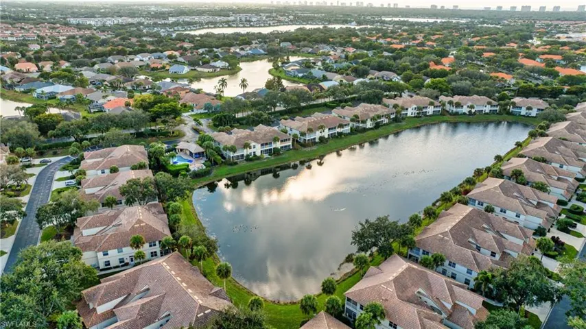 Aerial overview of property's location featuring a large body of water and nearby suburban area