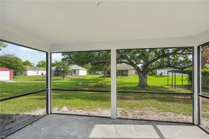Unfurnished sunroom featuring a residential view and plenty of natural light