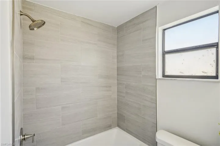 Bathroom with toilet and shower / bath combination