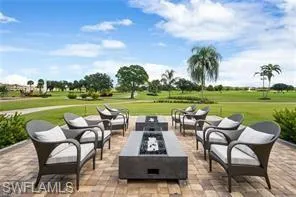 View of patio with an outdoor living space with a fire pit