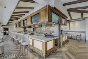 Kitchen with vaulted ceiling with beams and parquet flooring