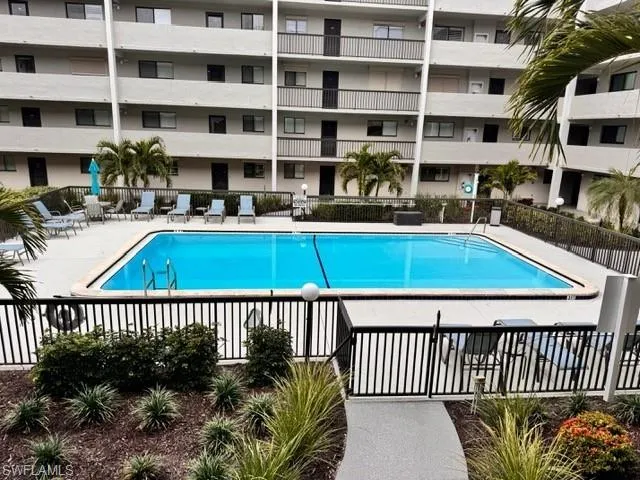 Community pool with a patio