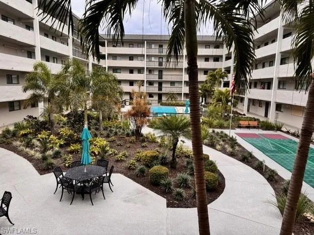 View of community featuring outdoor dining space, shuffleboard, and a patio