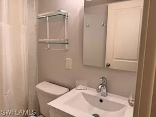 Full bath with vanity and curtained shower