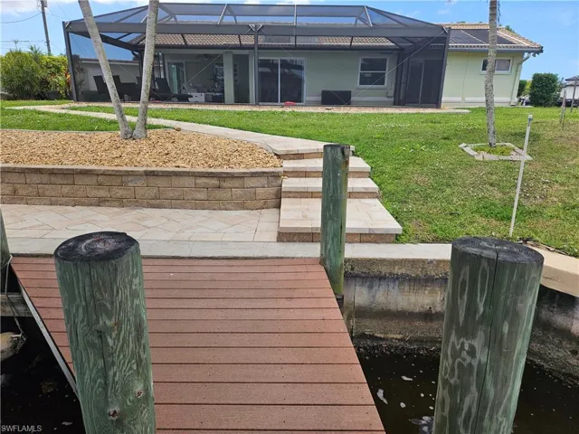 View of dock with glass enclosure and a yard