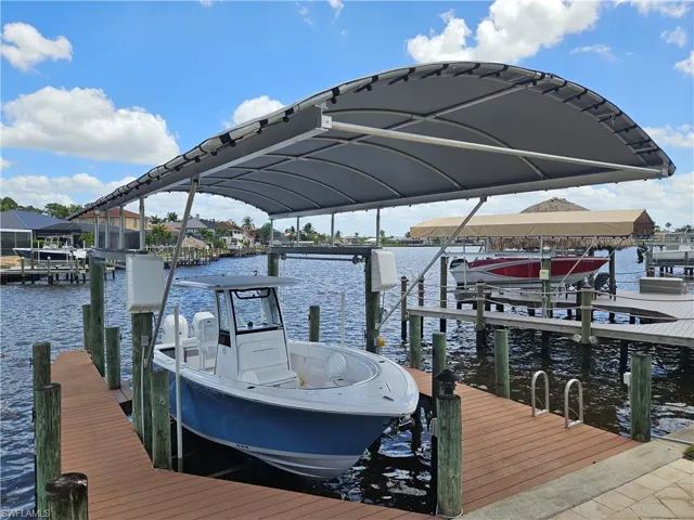View of dock featuring boat lift and a water view