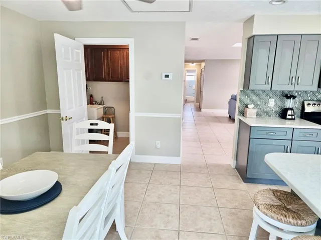 Dining room featuring light tile patterned floors and baseboards