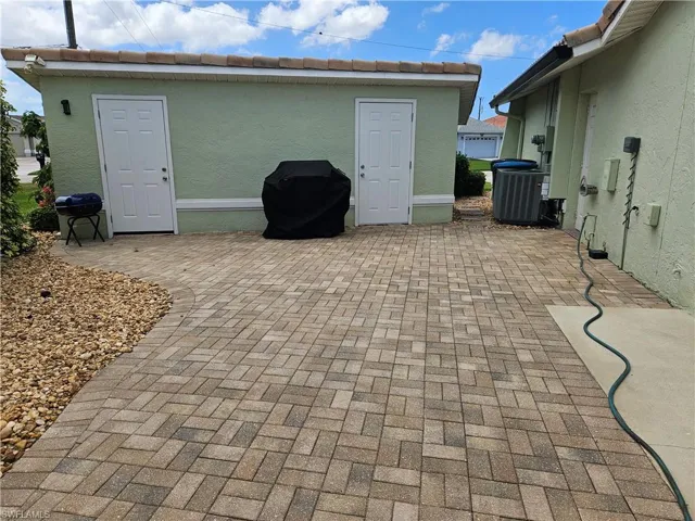 View of patio / terrace featuring an outdoor structure, area for grilling, and central AC