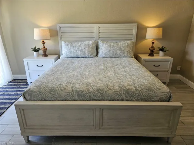 Bedroom with baseboards and wood finished floors