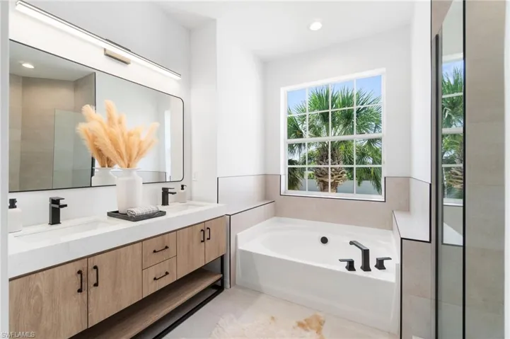 Brand new vanity, quartz counter, and a garden tub modernize this spa-like primary bath