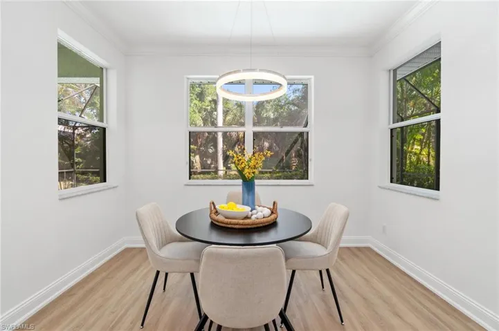 Eat-in dining area off of the kitchen looks out on to the pool and preserve