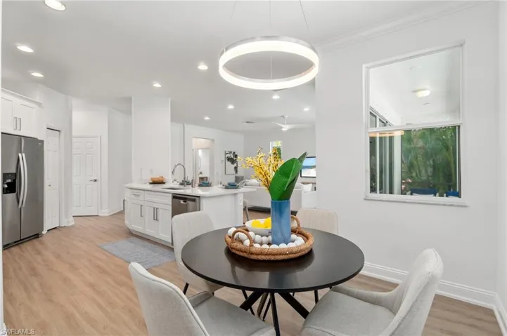 A modern light fixture adorns the eat-in dining space