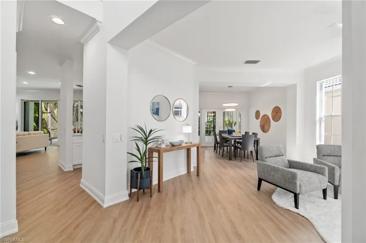 Entering the home an additional seating/living area is to the right, filled with natural light