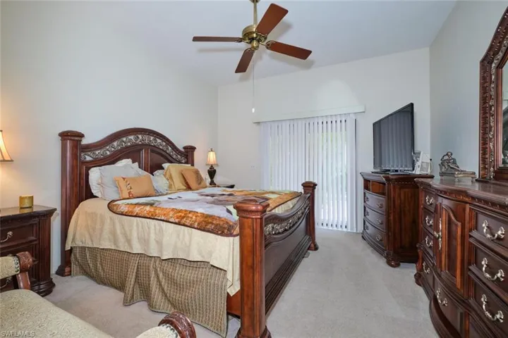 Bedroom featuring ceiling fan and light carpet