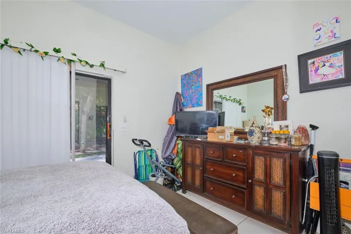 Bedroom featuring access to outside and light tile patterned flooring
