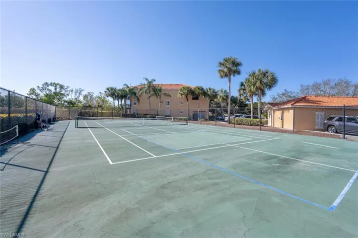 View of sport court featuring fence