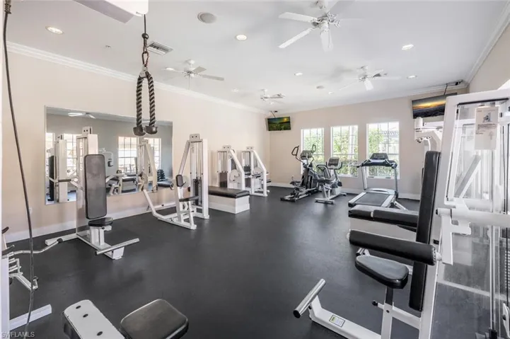 Gym with visible vents, ornamental molding, baseboards, and recessed lighting