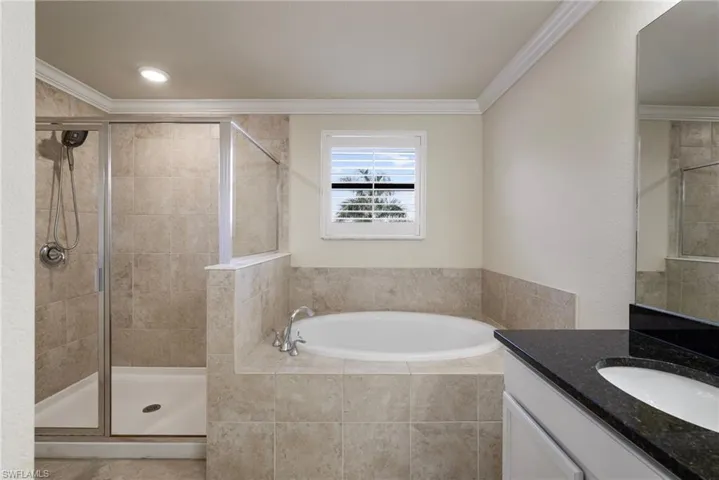 Bathroom featuring vanity, plus walk in shower