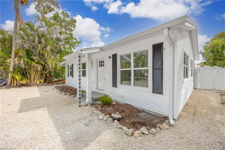 View of front of home with a gate, fence, and entry steps