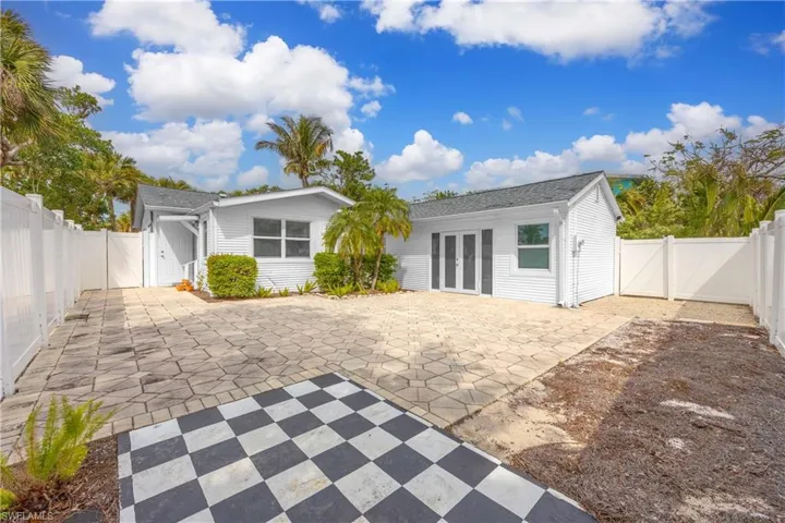 Back of house featuring french doors, a fenced backyard, a gate, and a patio