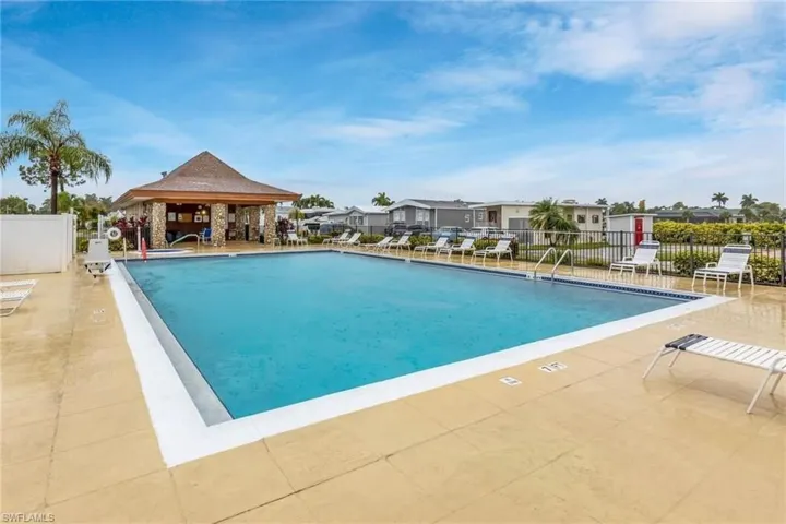 Community pool featuring a gazebo, a residential view, a patio, and fence