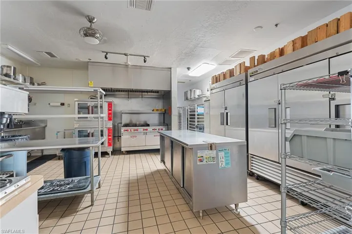 Kitchen with light tile patterned flooring, light countertops, visible vents, and a textured ceiling