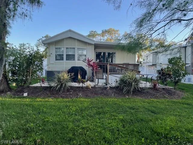 Back of house with a yard