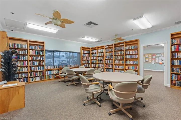 Rec room featuring visible vents, carpet flooring, and ornamental molding
