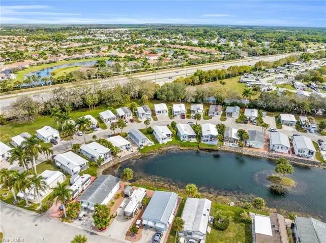 Drone / aerial view with a residential view and a water view