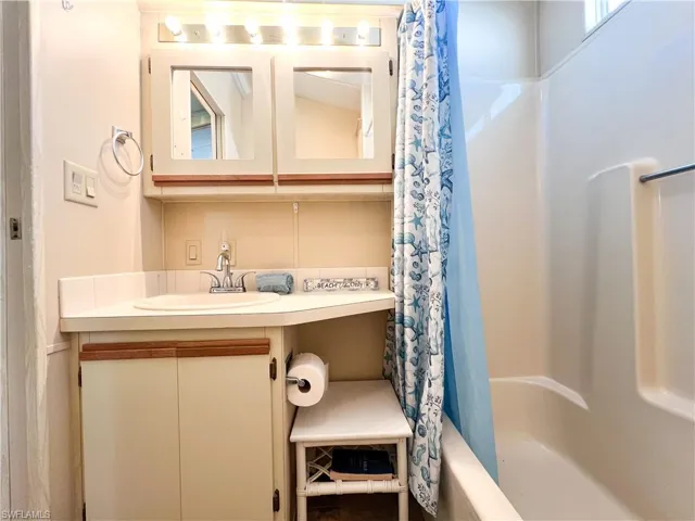 Full bathroom with vanity and shower / bathtub combination with curtain