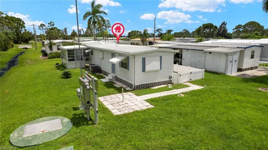 Rear view of house with a yard
