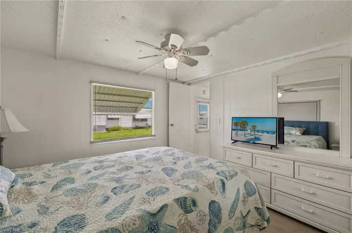 Bedroom featuring ceiling fan and a textured ceiling