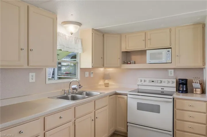 Kitchen featuring sink and white appliances