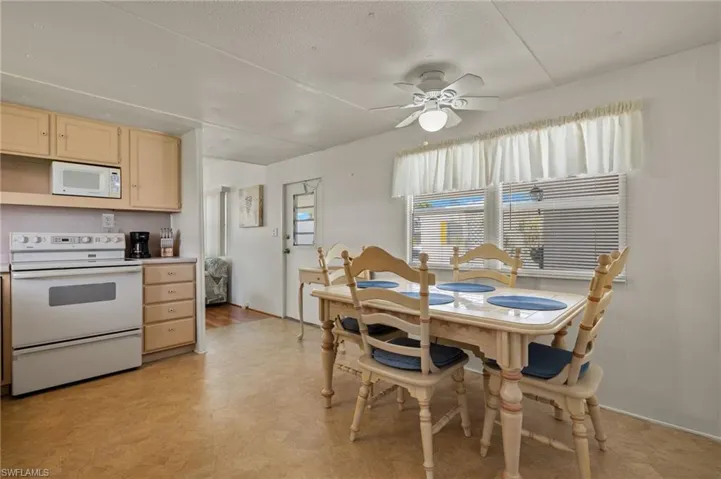 Dining room with ceiling fan and light hardwood / wood-style flooring