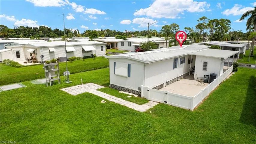 Rear view of house featuring a lawn