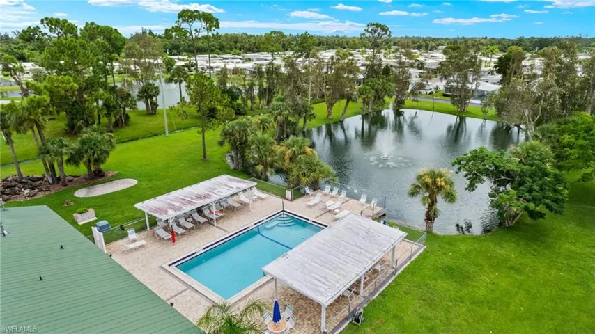 Birds eye view of property with a water view