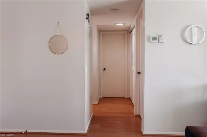 Hall featuring baseboards and light wood-style floors