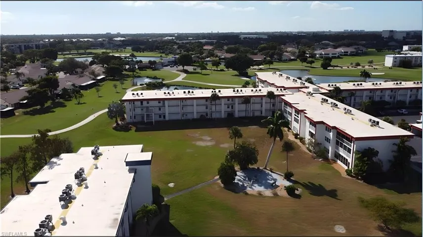 Aerial view of apartment complex and a nearby body of water