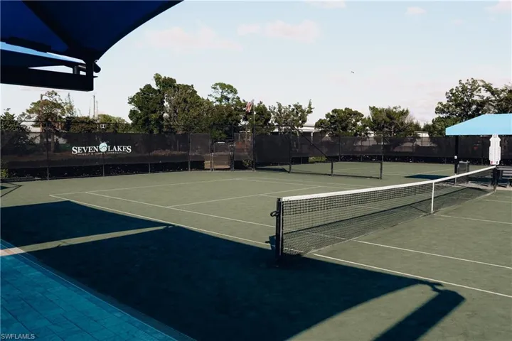 View of tennis court with community basketball court